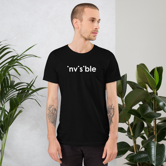 Mann trägt schwarzes Unisex T-Shirt mit weißem Invisible Schriftzug, bei dem die i-Punkte fehlen Brustprint