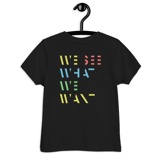 Schwarzes Kinder T-Shirt mit buntem We See What We Want Schriftzug